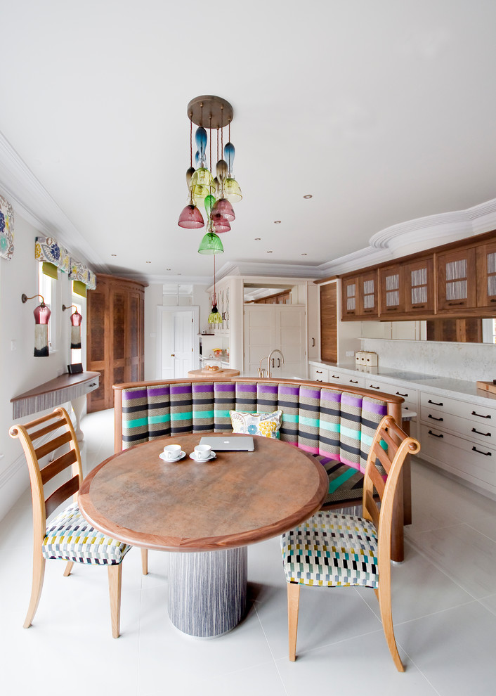 Photo of an eclectic l-shaped eat-in kitchen in Other with shaker cabinets, medium wood cabinets, white splashback and with island.