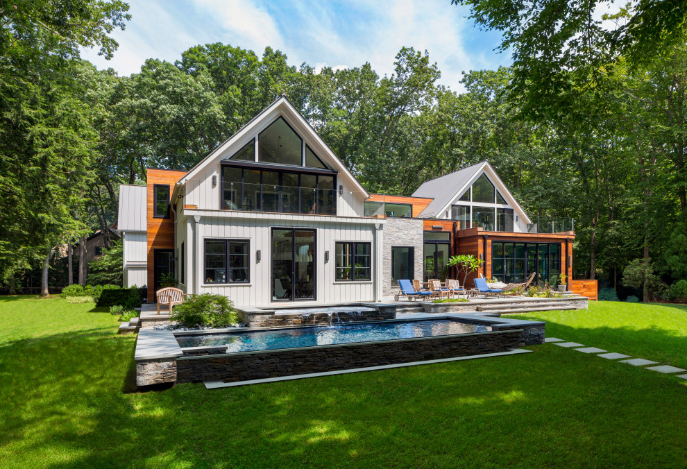 Cottage white two-story wood and clapboard exterior home idea in New York with a metal roof and a gray roof