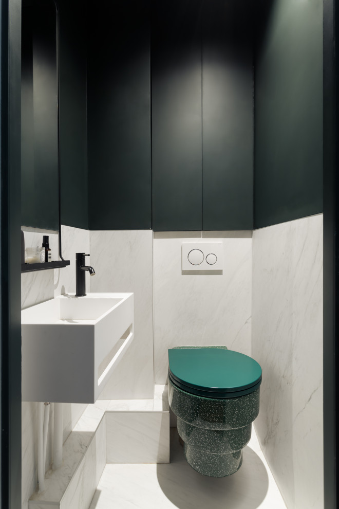 Inspiration for a medium sized modern cloakroom in Paris with beaded cabinets, green cabinets, a wall mounted toilet, white tiles, marble tiles, green walls, marble flooring, a wall-mounted sink, quartz worktops, white floors, white worktops and a floating vanity unit.
