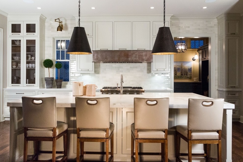 Photo of a mid-sized transitional galley separate kitchen in Boston with a farmhouse sink, shaker cabinets, white cabinets, marble benchtops, white splashback, subway tile splashback, stainless steel appliances, medium hardwood floors and with island.