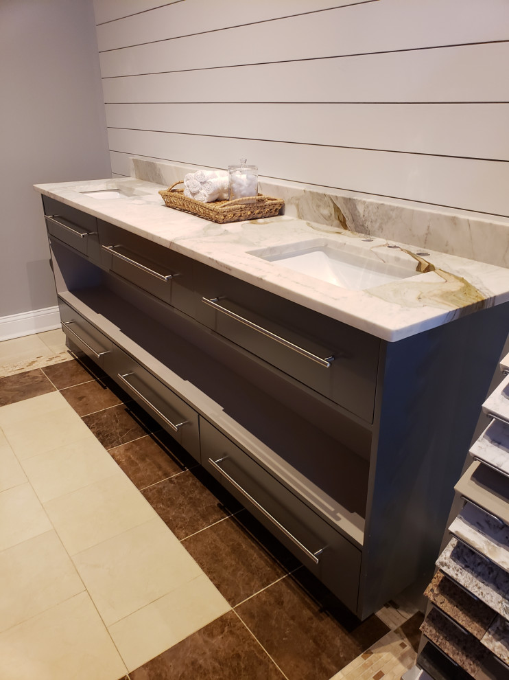 Inspiration for a mid-sized modern master bathroom in Atlanta with flat-panel cabinets, beige cabinets, gray tile, wood-look tile, grey walls, ceramic floors, a drop-in sink, engineered quartz benchtops, brown floor, multi-coloured benchtops, a double vanity and a built-in vanity.