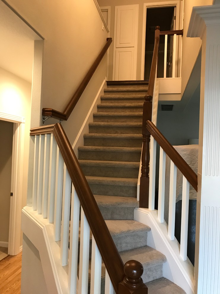 Inspiration for a mid-sized arts and crafts carpeted l-shaped staircase in Portland with concrete risers and wood railing.