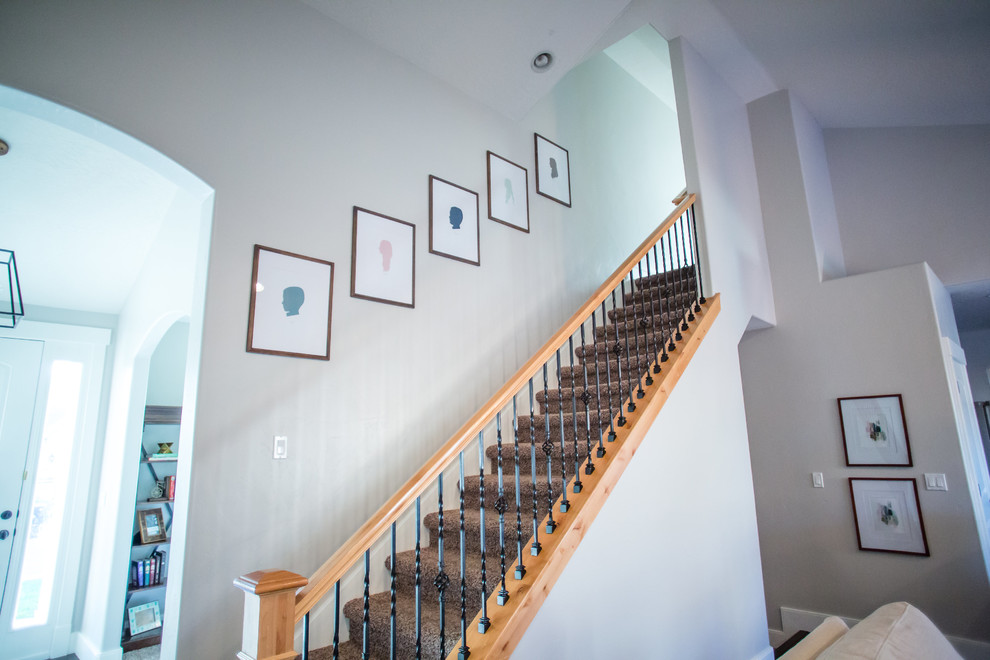 Mid-sized transitional carpeted straight staircase in Salt Lake City with concrete risers and mixed railing.