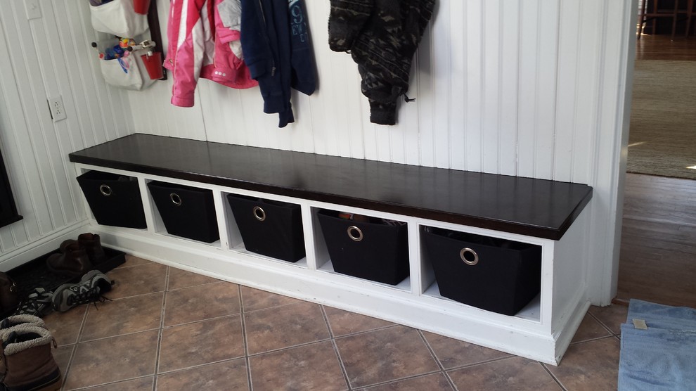 Inspiration for a small transitional ceramic tile and brown floor mudroom remodel in New York with white walls