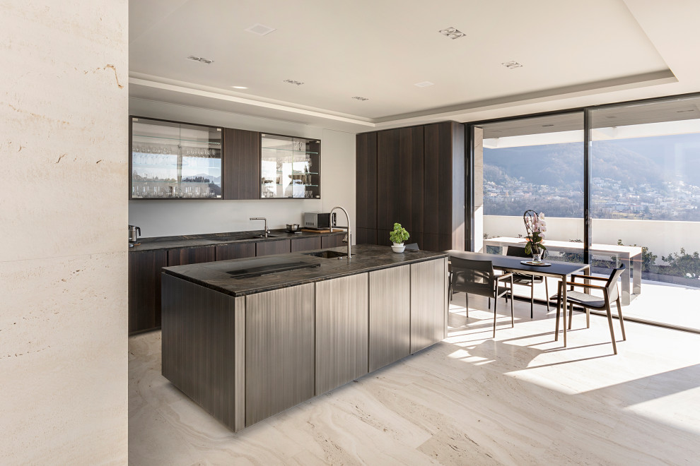 This is an example of a contemporary galley open plan kitchen in Milan with an integrated sink, marble benchtops, marble floors, with island, beige floor, brown benchtop, flat-panel cabinets, dark wood cabinets and recessed.