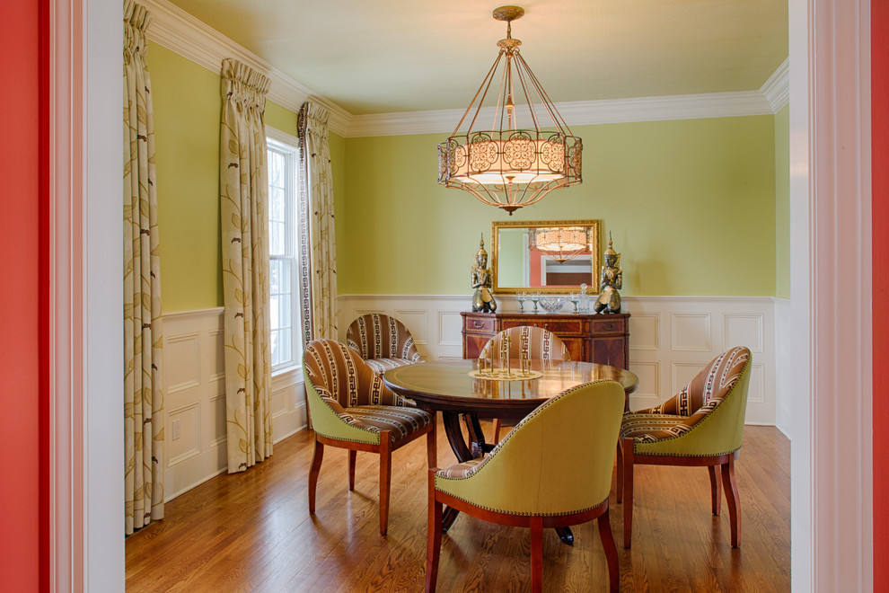 This is an example of a mid-sized asian separate dining room in New York with green walls, medium hardwood floors and no fireplace.