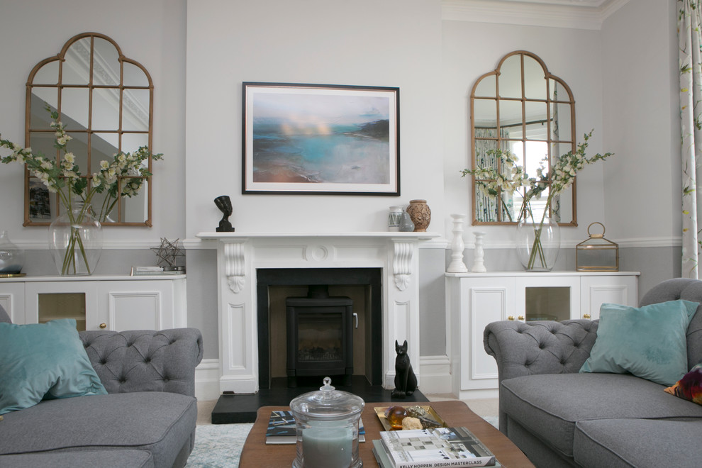 Design ideas for a large transitional open concept living room in Dorset with grey walls, carpet, a wood stove and a stone fireplace surround.