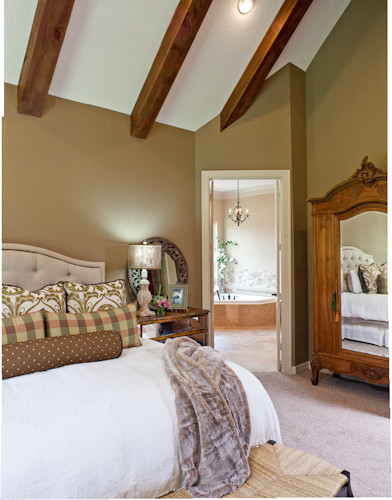 Large country master bedroom in Other with beige walls and carpet.
