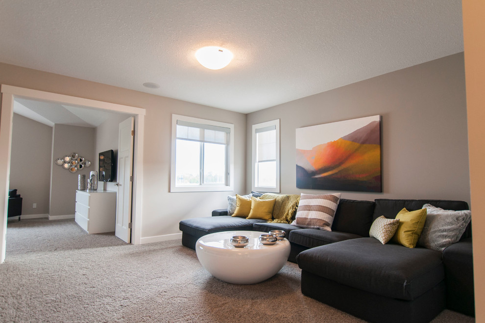 This is an example of a contemporary open concept family room in Edmonton with carpet.