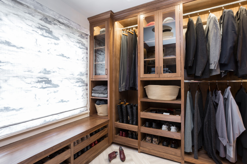 Transitional men's storage and wardrobe in Portland with dark wood cabinets and beige floor.