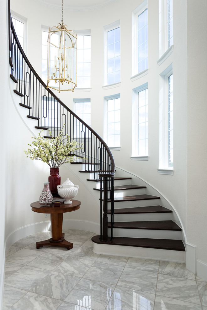 This is an example of a traditional foyer in Dallas with white walls, porcelain floors and white floor.
