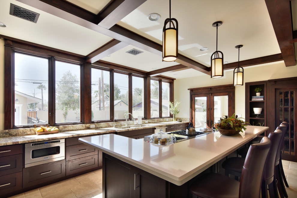 Large elegant kitchen photo in Phoenix with an undermount sink, shaker cabinets, dark wood cabinets, stainless steel appliances and an island