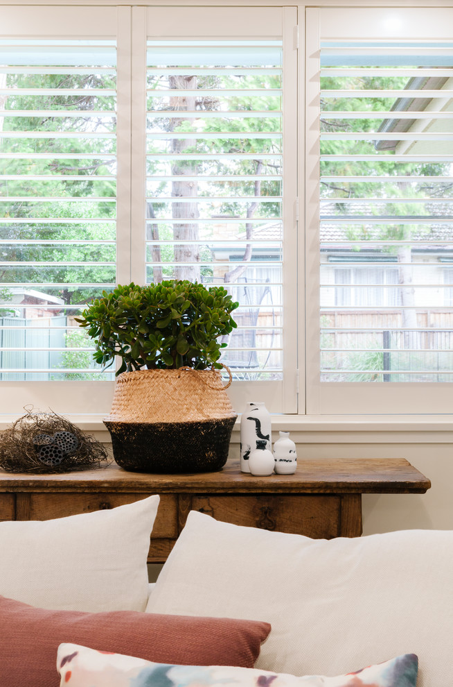 Inspiration for a mid-sized eclectic formal enclosed living room in Sydney with beige walls, carpet and beige floor.