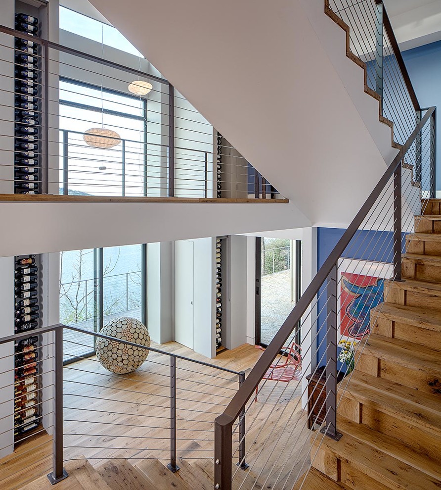 Large modern wood floating staircase in Austin with wood risers.
