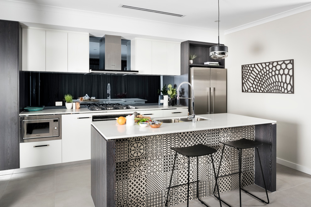 Small contemporary galley open plan kitchen in Perth with a double-bowl sink, flat-panel cabinets, black splashback, glass sheet splashback, stainless steel appliances and with island.
