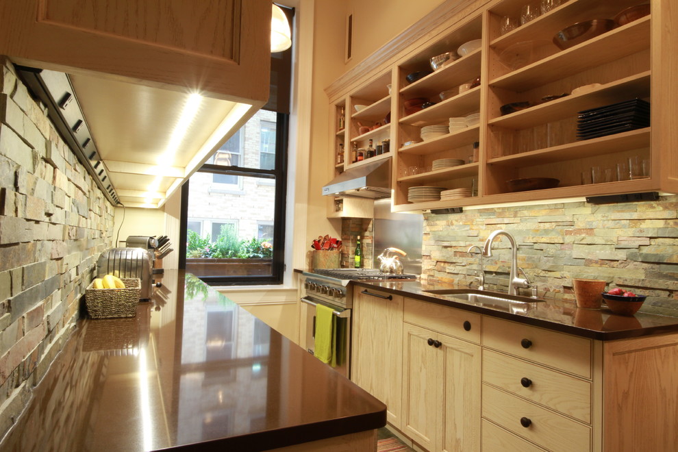 Example of a mid-sized transitional galley terra-cotta tile open concept kitchen design in New York with glass-front cabinets, light wood cabinets, multicolored backsplash, stainless steel appliances, no island, an undermount sink, solid surface countertops and stone tile backsplash