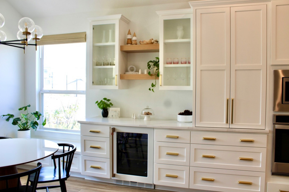 This is an example of a small traditional l-shaped dry bar in Austin with white cabinets, quartz worktops, white splashback and white worktops.