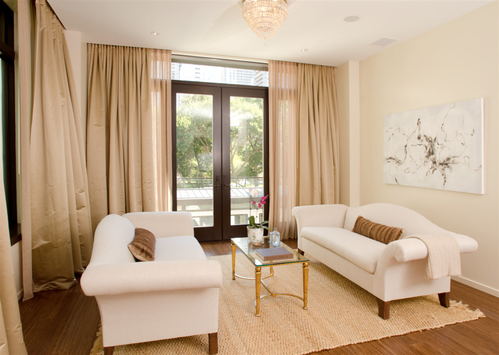 This is an example of a small contemporary enclosed living room in Chicago with beige walls and bamboo floors.