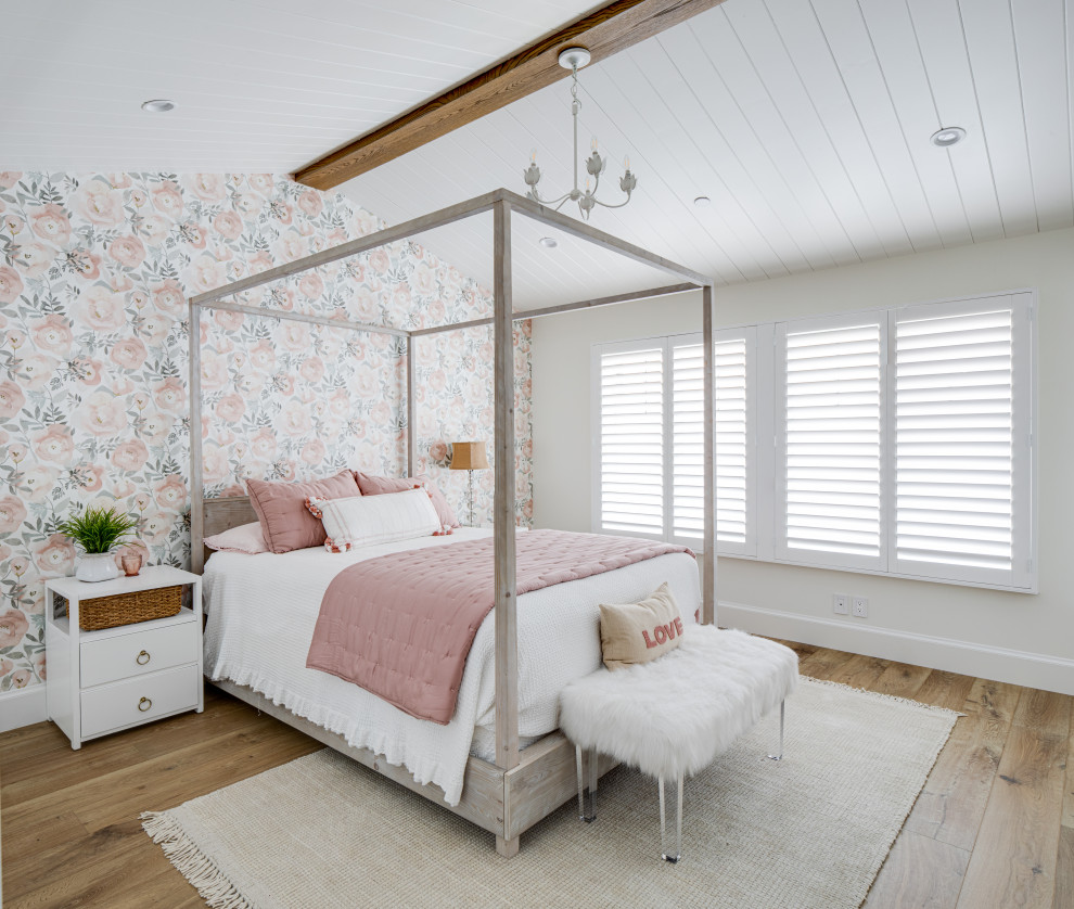 This is an example of a beach style kids' bedroom for girls in Orange County with white walls, light hardwood flooring, a wood ceiling and wallpapered walls.