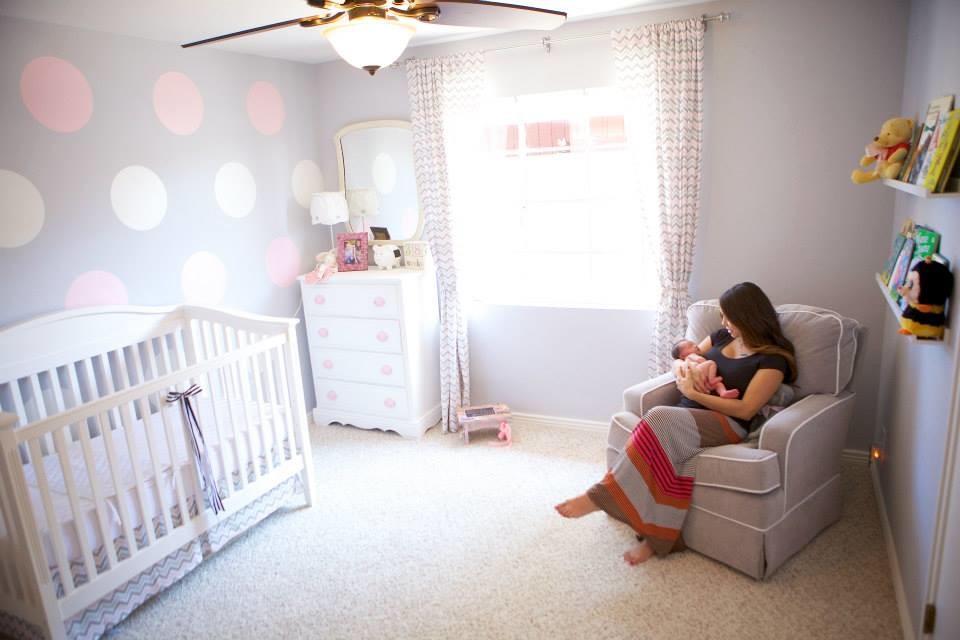 Large transitional nursery with grey walls, carpet and beige floor for girls.