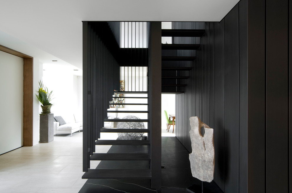 Photo of a mid-sized contemporary u-shaped staircase in Melbourne with open risers.