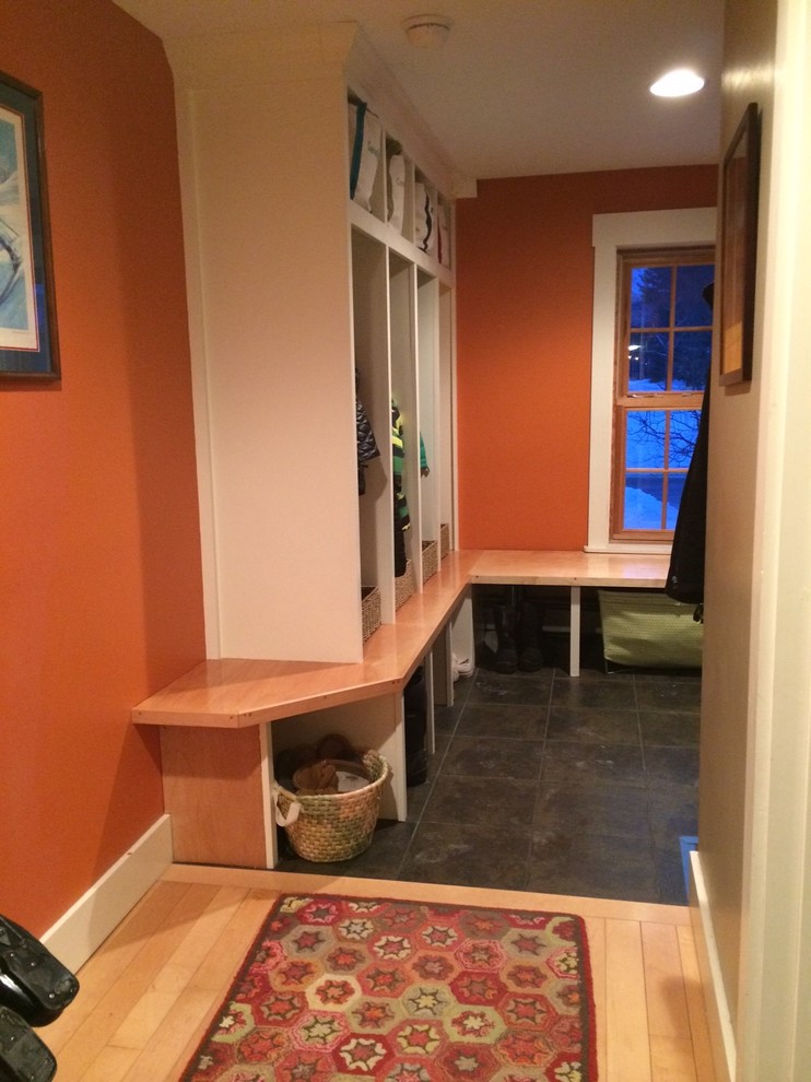 Design ideas for a small country mudroom in Boston with orange walls and porcelain floors.