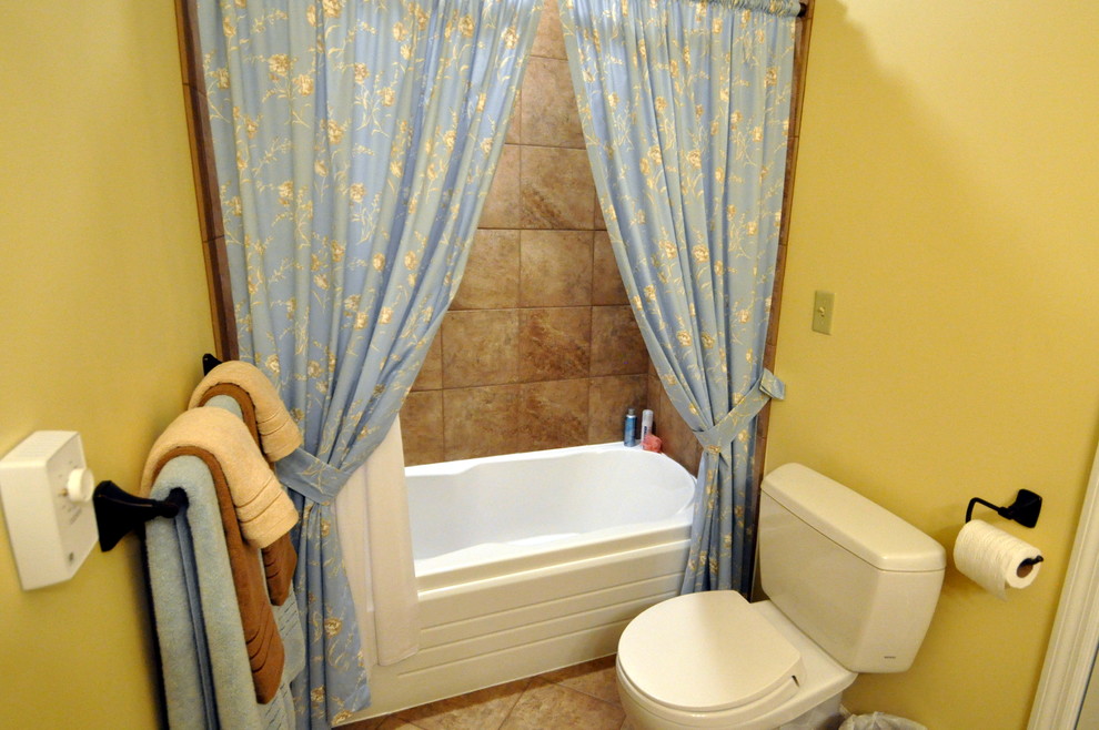 Example of a transitional porcelain tile alcove bathtub design in Chicago with an undermount sink and flat-panel cabinets