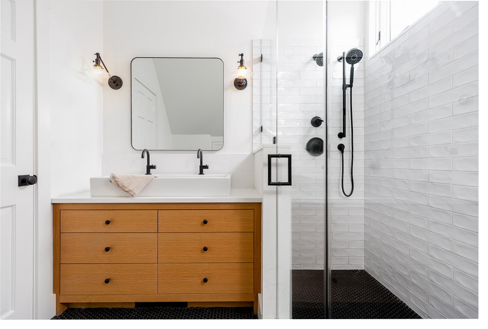 Inspiration for a mid-sized transitional 3/4 bathroom in Burlington with flat-panel cabinets, medium wood cabinets, an open shower, a one-piece toilet, white tile, ceramic tile, white walls, porcelain floors, a vessel sink, quartzite benchtops, black floor, white benchtops, a single vanity, a built-in vanity and vaulted.