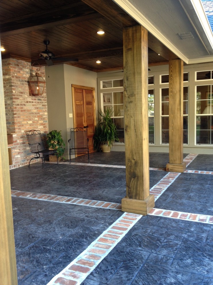 Inspiration for a large country backyard patio in New Orleans with an outdoor kitchen, a roof extension and stamped concrete.
