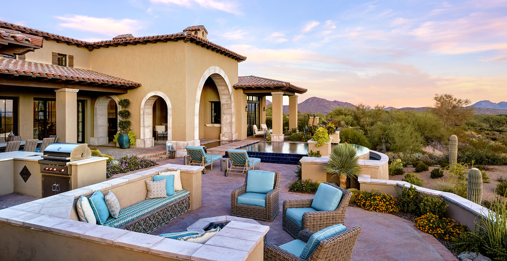 Inspiration for a mediterranean backyard patio in Phoenix with an outdoor kitchen.