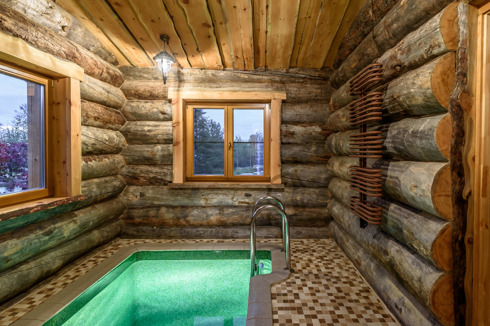 Country rectangular pool in Moscow with a hot tub and tile.