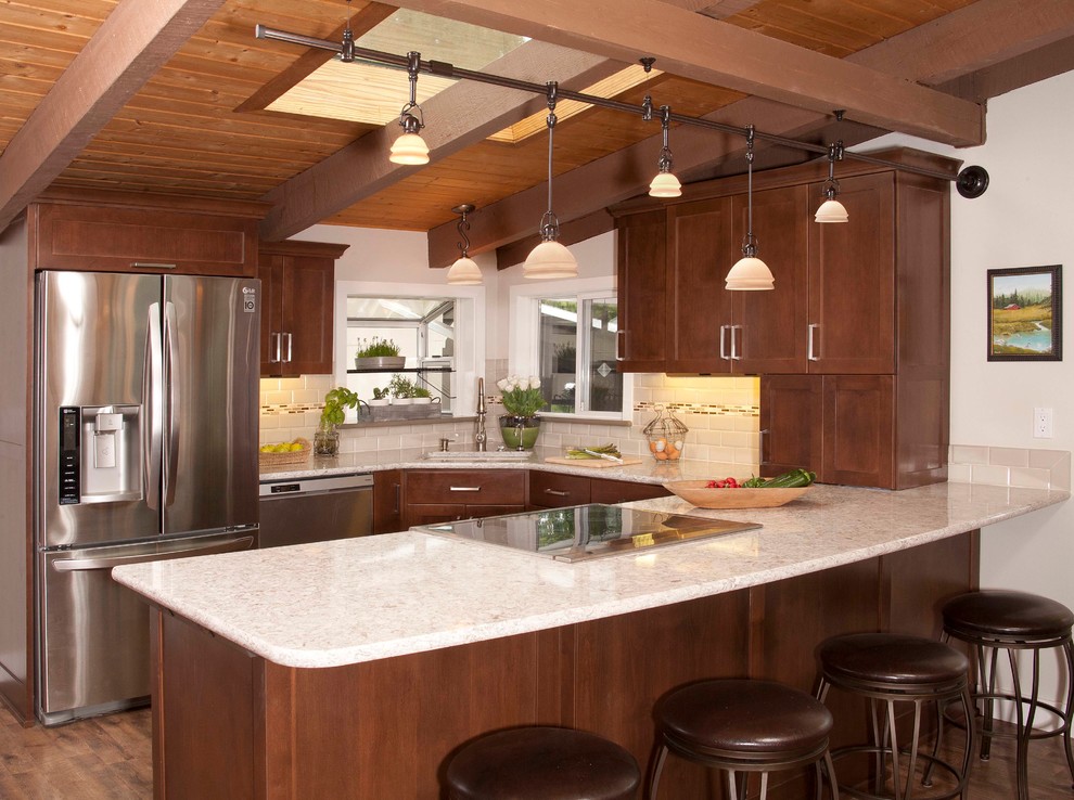 Mid-sized transitional dark wood floor kitchen photo in Seattle with an undermount sink, shaker cabinets, dark wood cabinets, beige backsplash, subway tile backsplash, stainless steel appliances and a peninsula