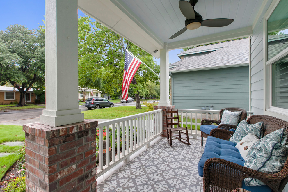 Mid-sized elegant tile front porch photo in Austin with a roof extension