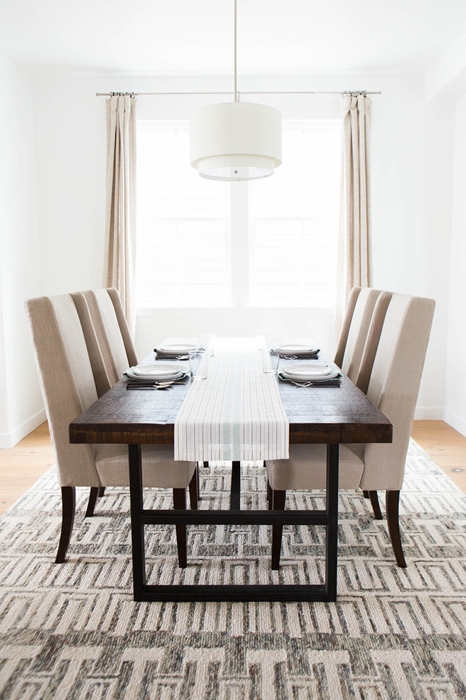 Transitional dining room in Salt Lake City with white walls and light hardwood floors.
