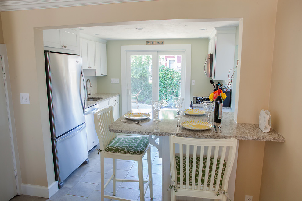 Design ideas for a small beach style galley separate kitchen in Boston with an undermount sink, shaker cabinets, white cabinets, granite benchtops, stainless steel appliances, ceramic floors and a peninsula.