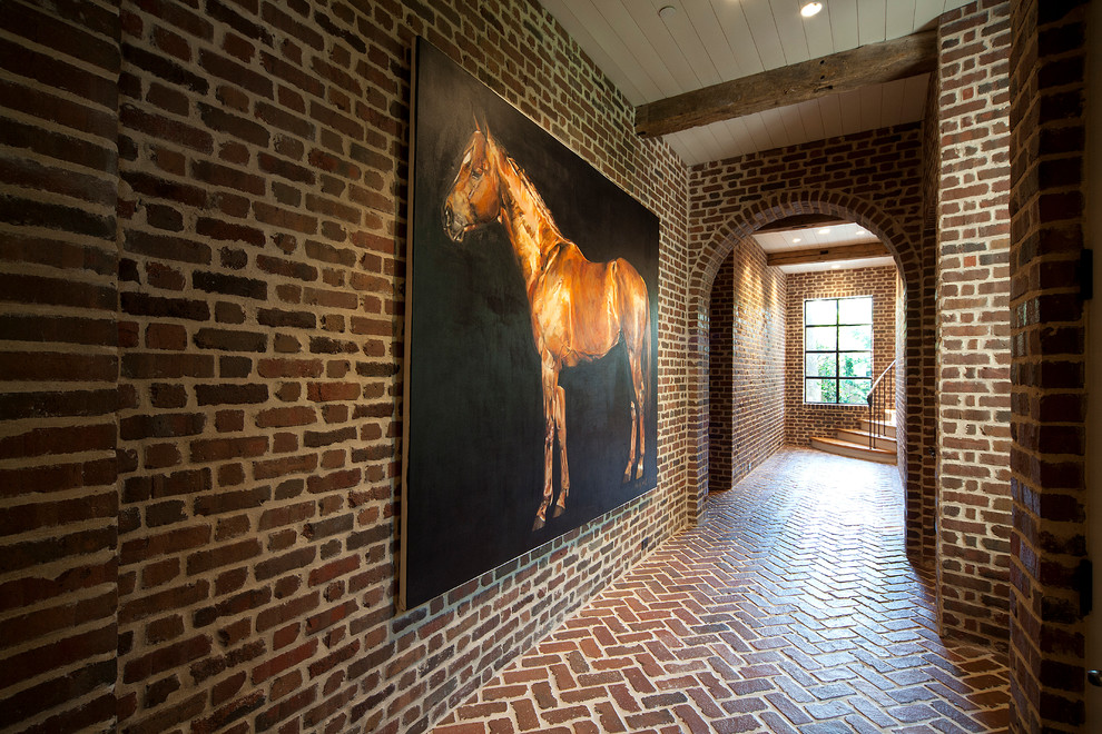 Photo of a country hallway in Houston with brick floors.