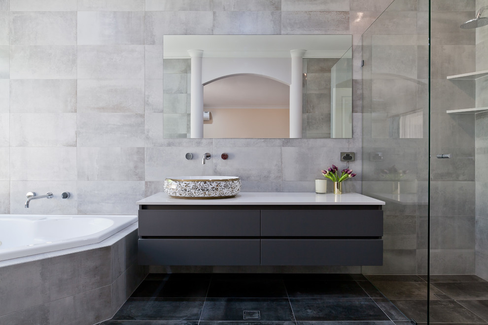 Mid-sized contemporary master bathroom in Perth with flat-panel cabinets, grey cabinets, a curbless shower, a one-piece toilet, gray tile, porcelain tile, grey walls, porcelain floors, a vessel sink, engineered quartz benchtops, grey floor, a hinged shower door and white benchtops.