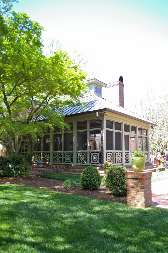 Photo of a large traditional backyard screened-in verandah in Charlotte.