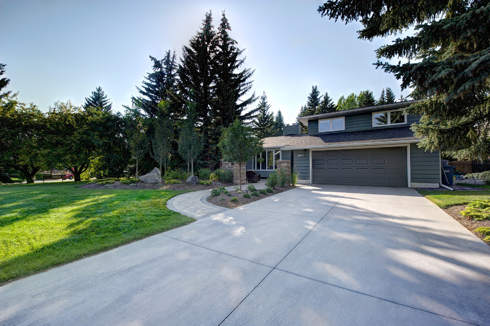 Mid-sized traditional front yard driveway in Calgary with concrete pavers.