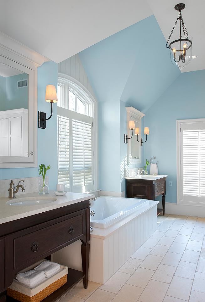 This is an example of a large master bathroom in Portland Maine with an undermount sink, dark wood cabinets, a drop-in tub, a one-piece toilet, white tile and blue walls.