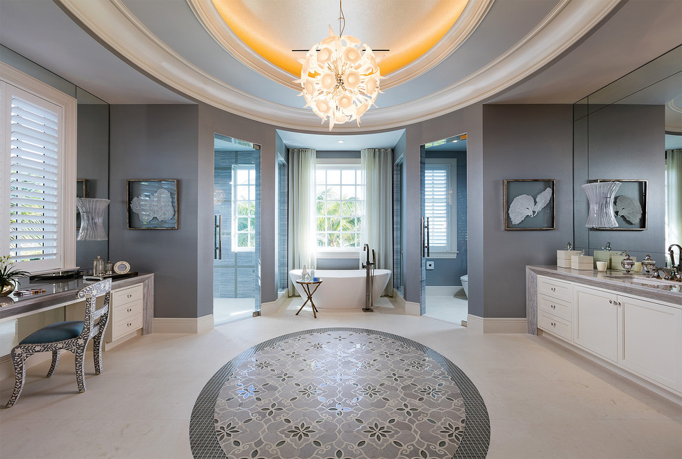 This is an example of an expansive traditional master bathroom in Other with recessed-panel cabinets, white cabinets, a freestanding tub, a one-piece toilet, beige tile, beige walls, porcelain floors, an integrated sink, granite benchtops, multi-coloured floor and multi-coloured benchtops.