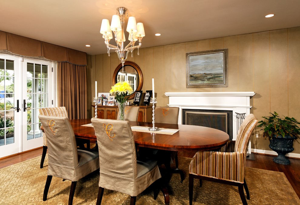 Design ideas for a traditional dining room in DC Metro with beige walls, dark hardwood floors and a standard fireplace.