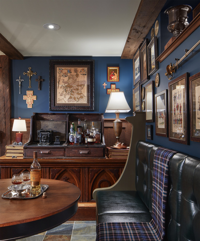 Inspiration for a traditional home bar in Minneapolis with dark wood cabinets, dark hardwood floors and brown floor.