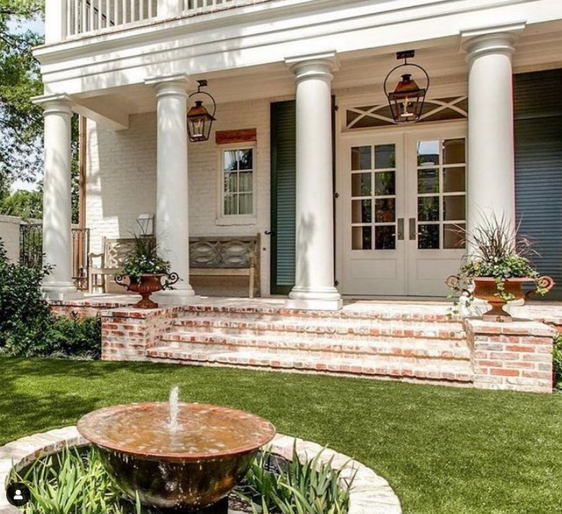 Photo of a mid-sized arts and crafts front yard verandah in Houston with a water feature, brick pavers, a roof extension and mixed railing.