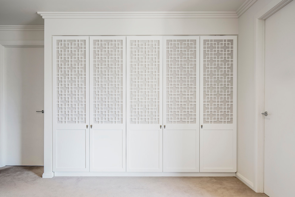 Inspiration for a mid-sized asian hallway in Melbourne with white walls and carpet.