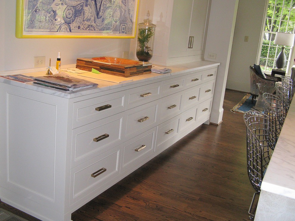Open concept kitchen - mid-sized transitional open concept kitchen idea in Charlotte with flat-panel cabinets, white cabinets, marble countertops and an island