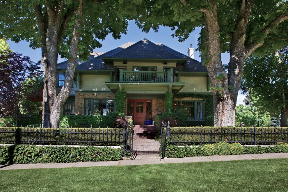 Photo of an arts and crafts two-storey green exterior in Salt Lake City with a hip roof.
