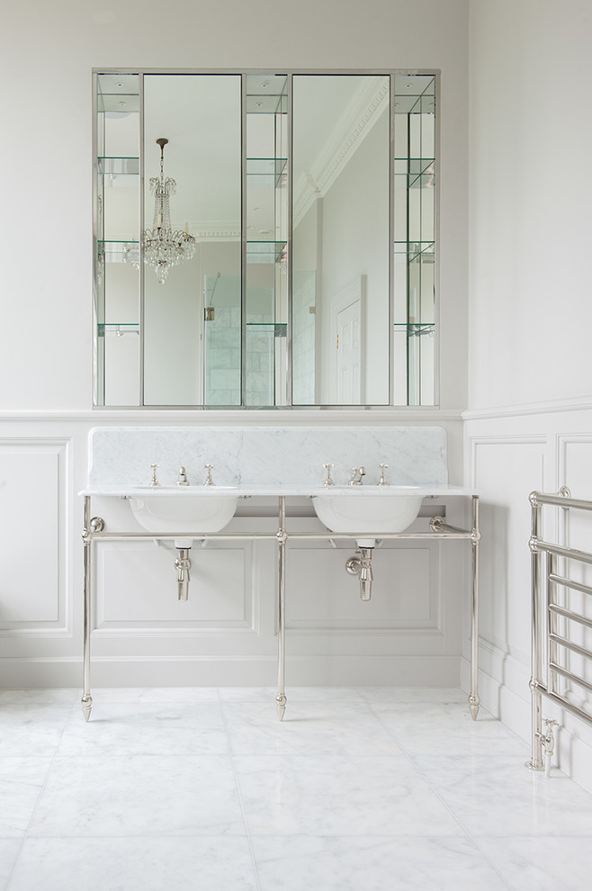 This is an example of a traditional bathroom in London with white tile, stone slab, white walls and marble floors.