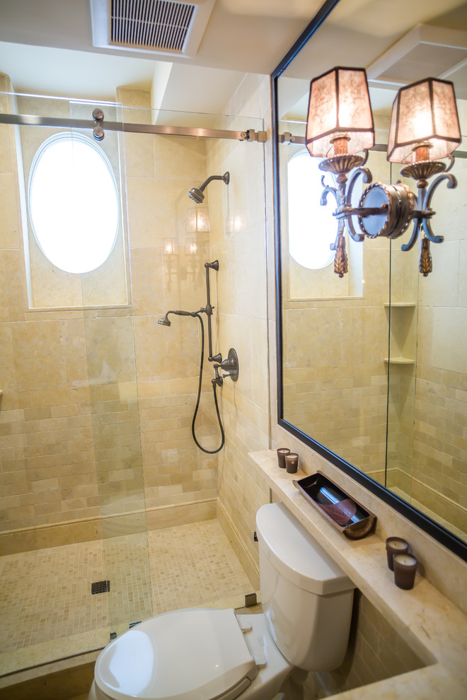 Photo of a mid-sized mediterranean bathroom in DC Metro with an alcove shower, a one-piece toilet, beige tile, beige walls and a sliding shower screen.