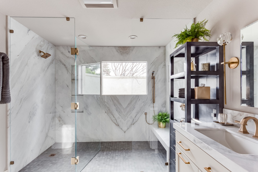 Design ideas for a large transitional master bathroom in Sacramento with shaker cabinets, grey cabinets, a curbless shower, a one-piece toilet, white tile, stone slab, grey walls, porcelain floors, an undermount sink, marble benchtops, grey floor, a hinged shower door and white benchtops.